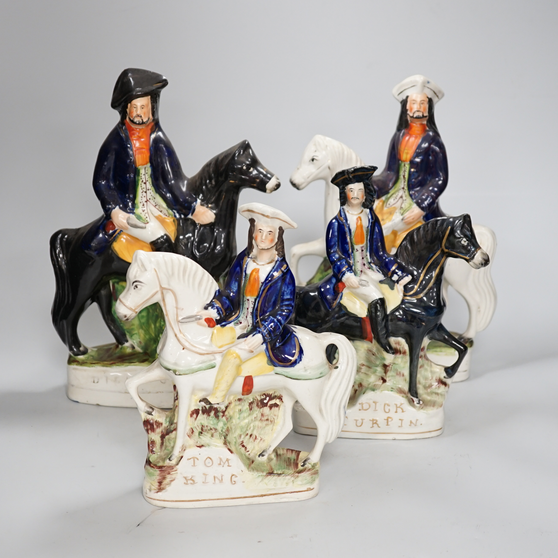 Two pairs of Staffordshire highwaymen figure groups of Tom King and Dick Turpin, the largest 30cm high
